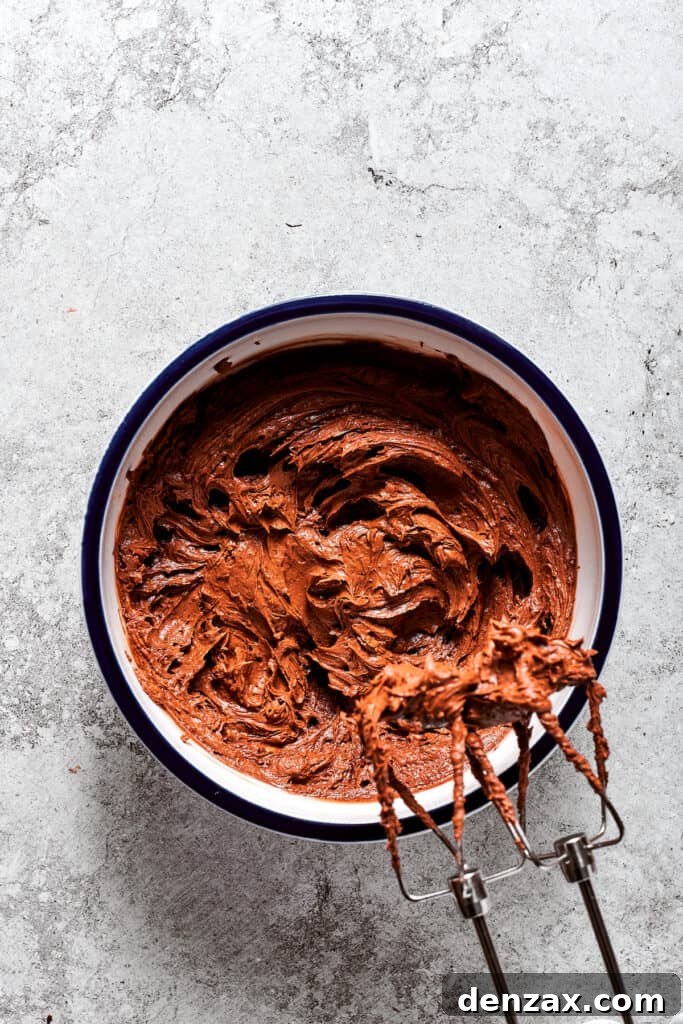 The fluffy, creamed butter is being blended with the chocolate-egg mixture, creating the rich French Silk Pie filling.