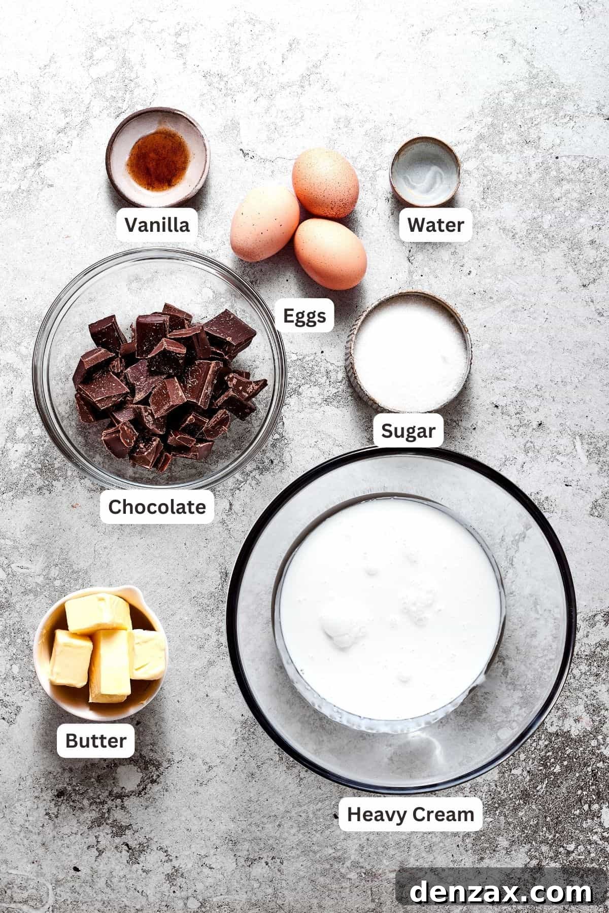 The filling ingredients for French silk pie are displayed: finely chopped chocolate, large eggs, vanilla extract, heavy cream, water, granulated sugar, and unsalted butter.