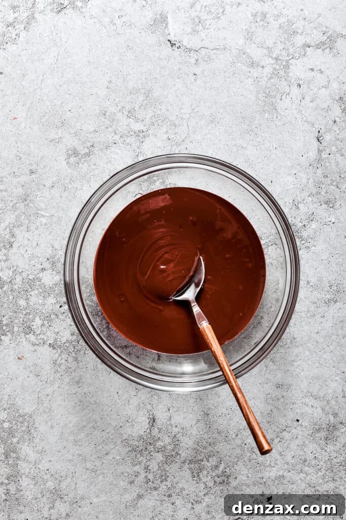 Melted bittersweet chocolate in a glass bowl, ready for the next step of the French Silk Pie filling.