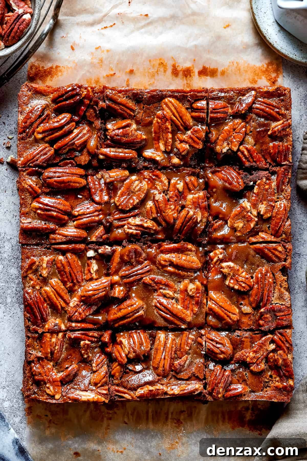 An inviting overhead shot of delicious pecan-topped brownies neatly cut into squares, ready to be enjoyed.