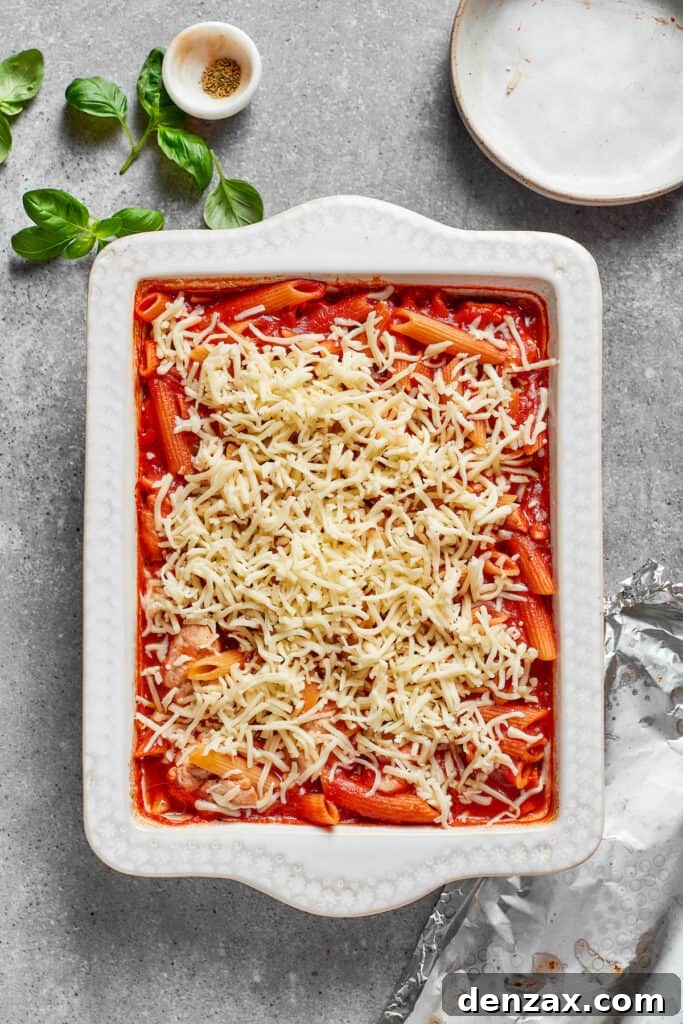 Shredded cheese is added to the casserole.