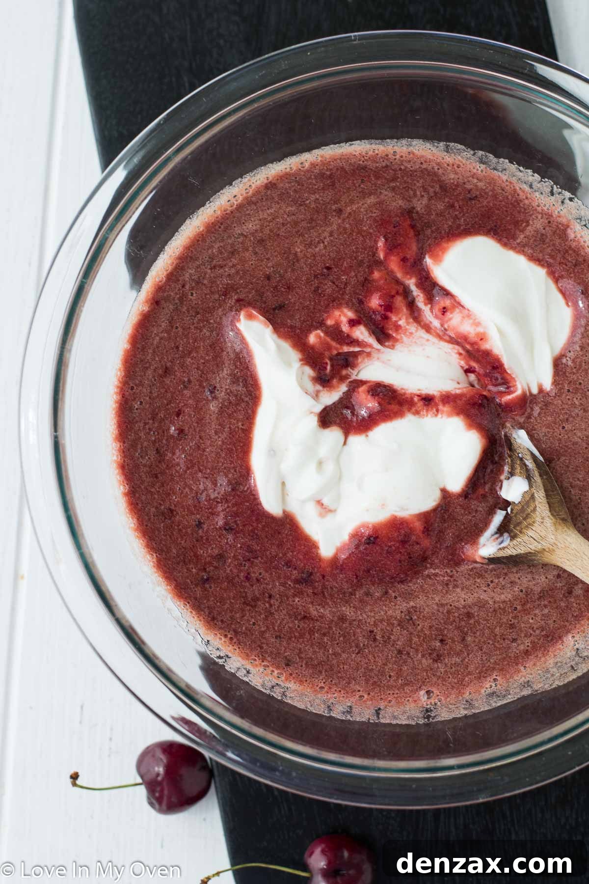 Mixing cherry puree with Greek yogurt