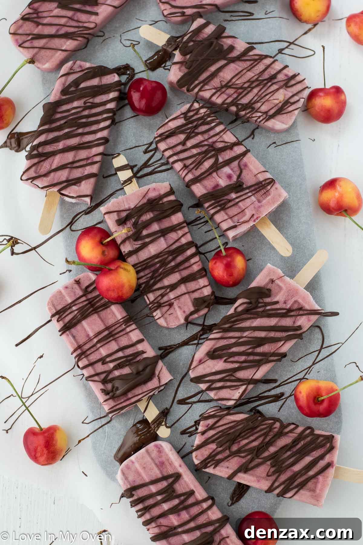 Greek yogurt cherry popsicles with chocolate drizzle