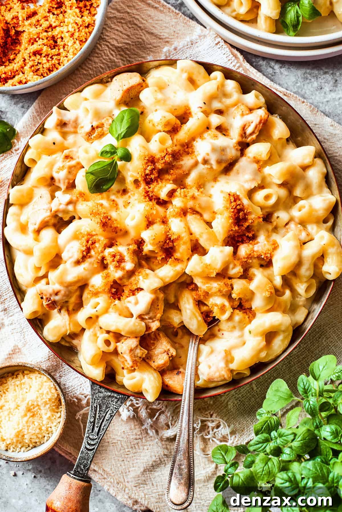 Stirring through macaroni and cheese in a skillet.