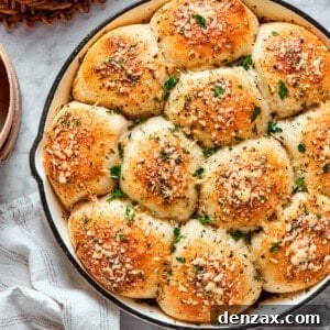 A skillet of baked pizza bites next to a bowl of sauce.
