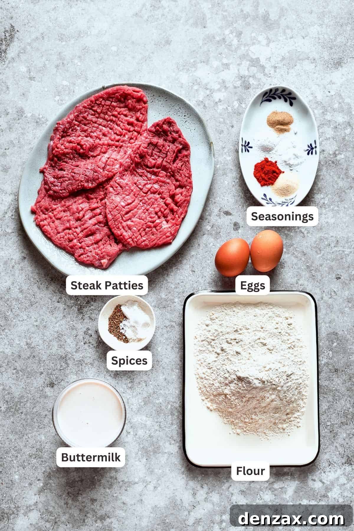 A selection of ingredients for the chicken fried steak, including cube steak, eggs, flour, and various seasonings.