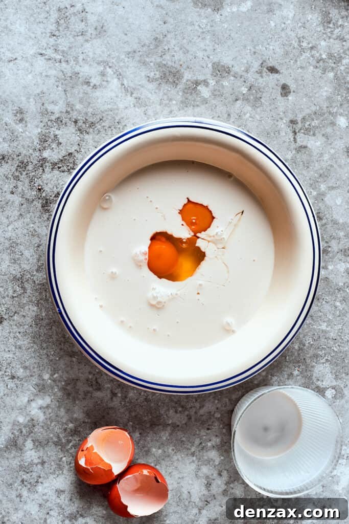 Buttermilk and eggs being whisked together in a bowl.