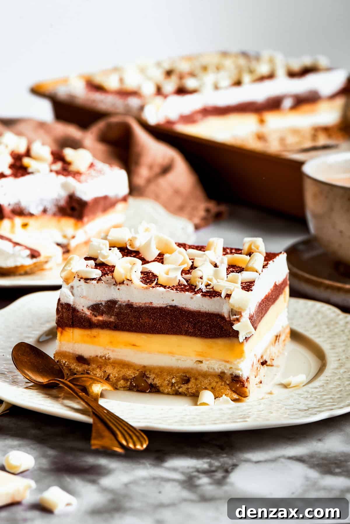 Several neatly cut squares of Sex in a Pan dessert are arranged on a white plate, showcasing the distinct layers and ready to be served.