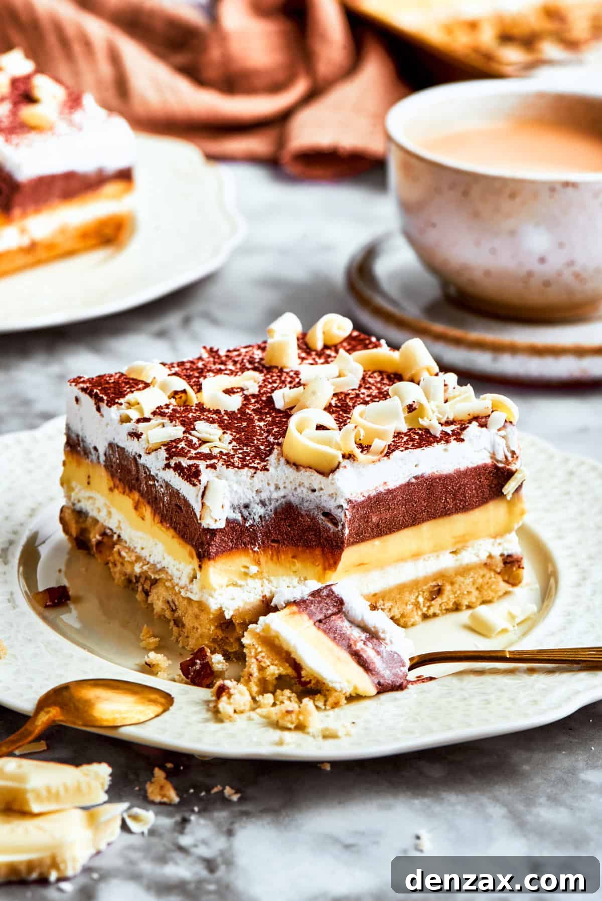 A perfectly portioned slice of Sex in a Pan dessert, showcasing its beautiful layers of chocolate, vanilla, and cream cheese on a pecan crust, ready to be enjoyed.