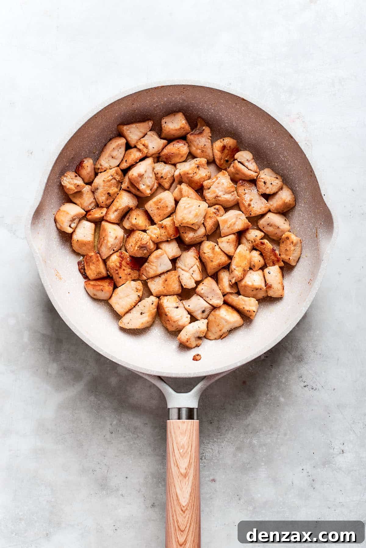 This Teriyaki Chicken Recipe folds tender bites of chicken into a thick, homemade teriyaki sauce for a savory and flavorful dish. Chicken pieces are browned in a skillet for teriyaki chicken recipe.