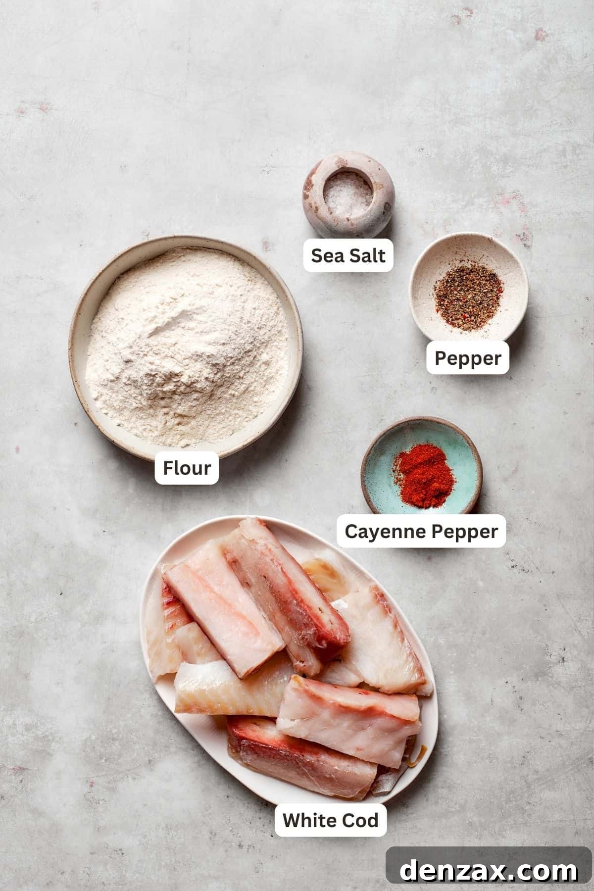 All the fresh ingredients for beer battered fish laid out on a wooden surface.