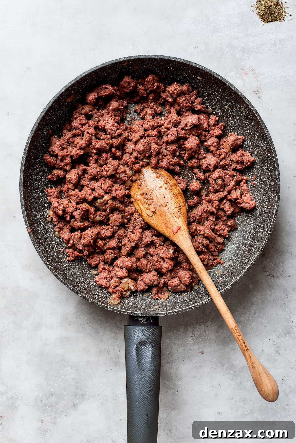 The beef is browned in a skillet.