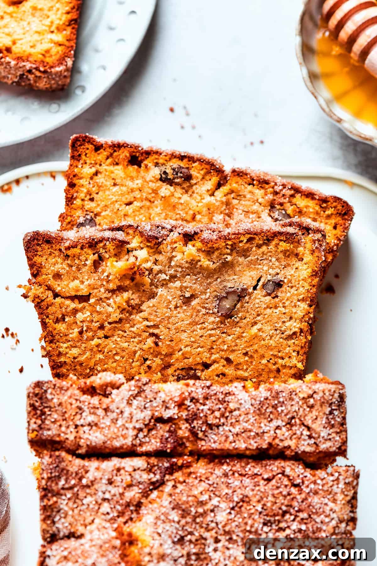 Thick slices of Amish friendship bread are artfully arranged on a white plate.