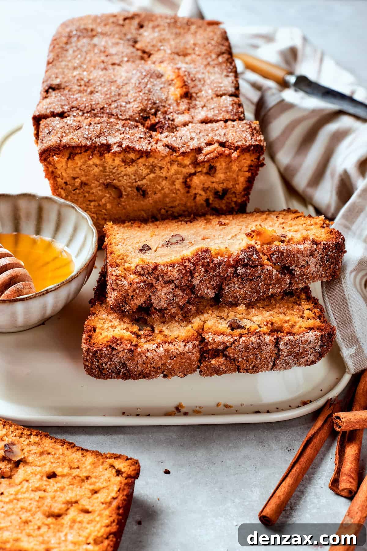 Slices of Amish friendship bread are buttered on a plate, ready to be enjoyed.