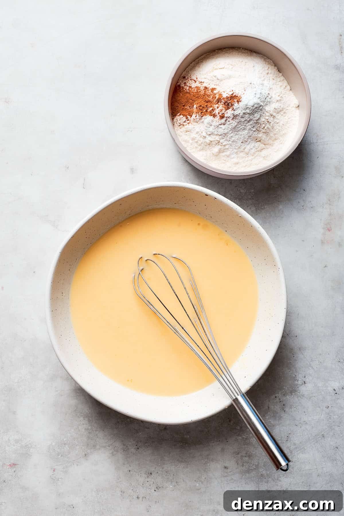 The eggs are whisked smoothly into the wet ingredients, creating a homogeneous batter.