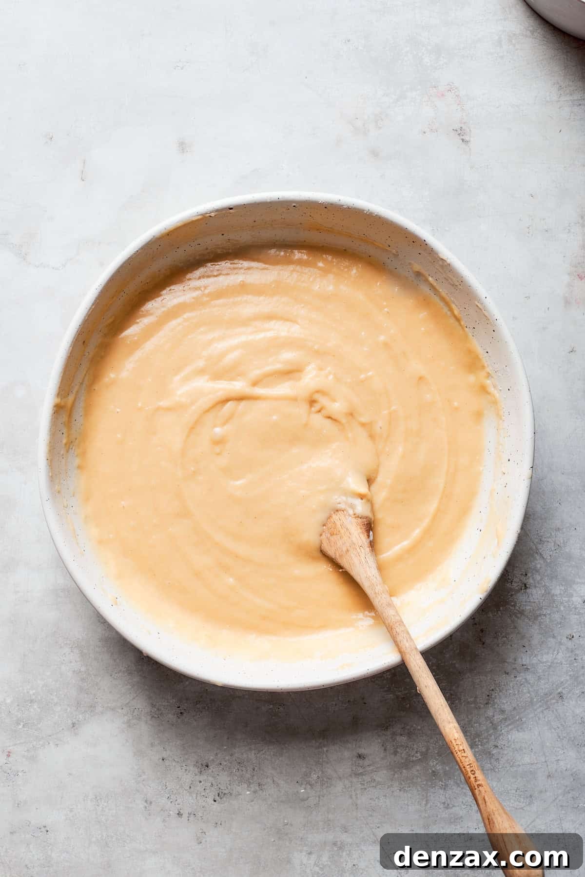 The bread batter is stirred until it achieves a smooth and uniform consistency.