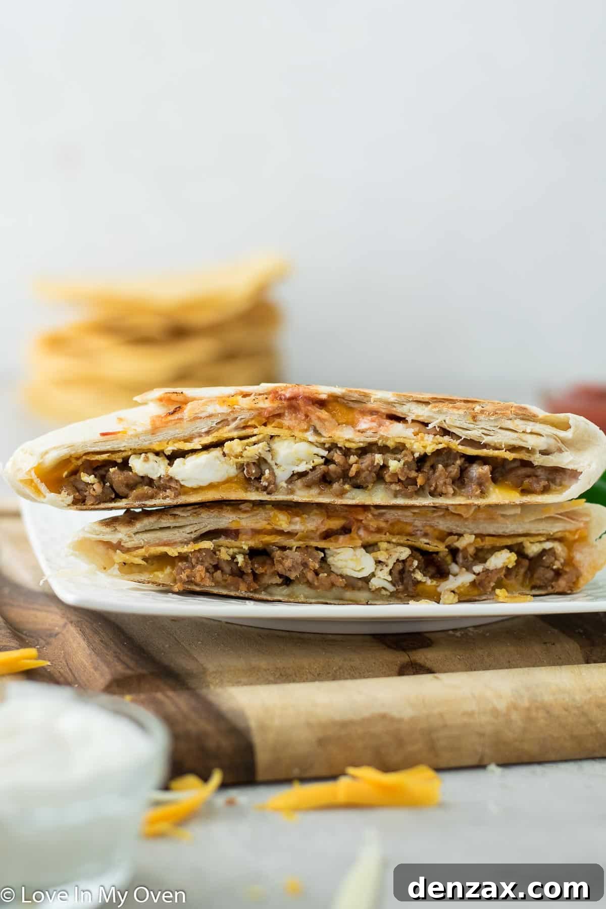 A sliced breakfast crunch wrap, showing the layers of filling.