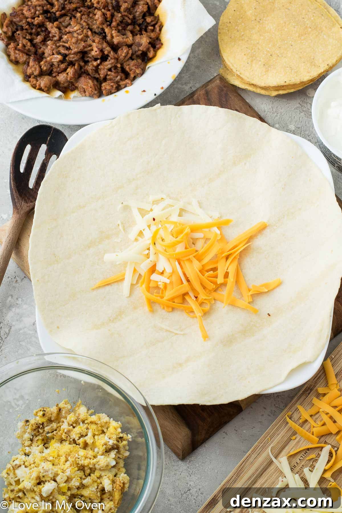 Ingredients for a Cheesy Breakfast Crunch Wrap including chorizo, eggs, tortillas, and cheese.