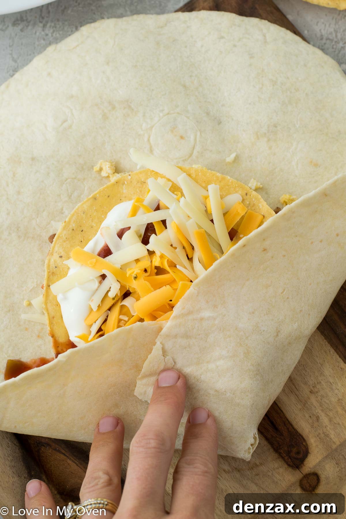 Placing a tostada for crunch in the breakfast wrap.