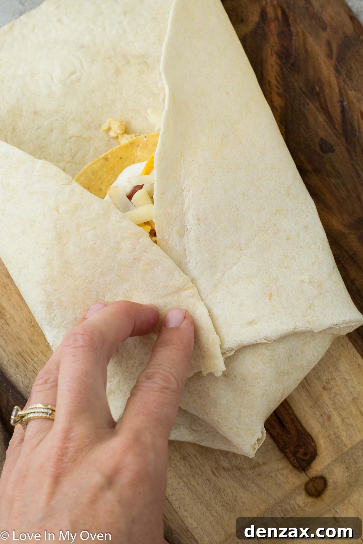 Adding sour cream and salsa on top of the tostada.