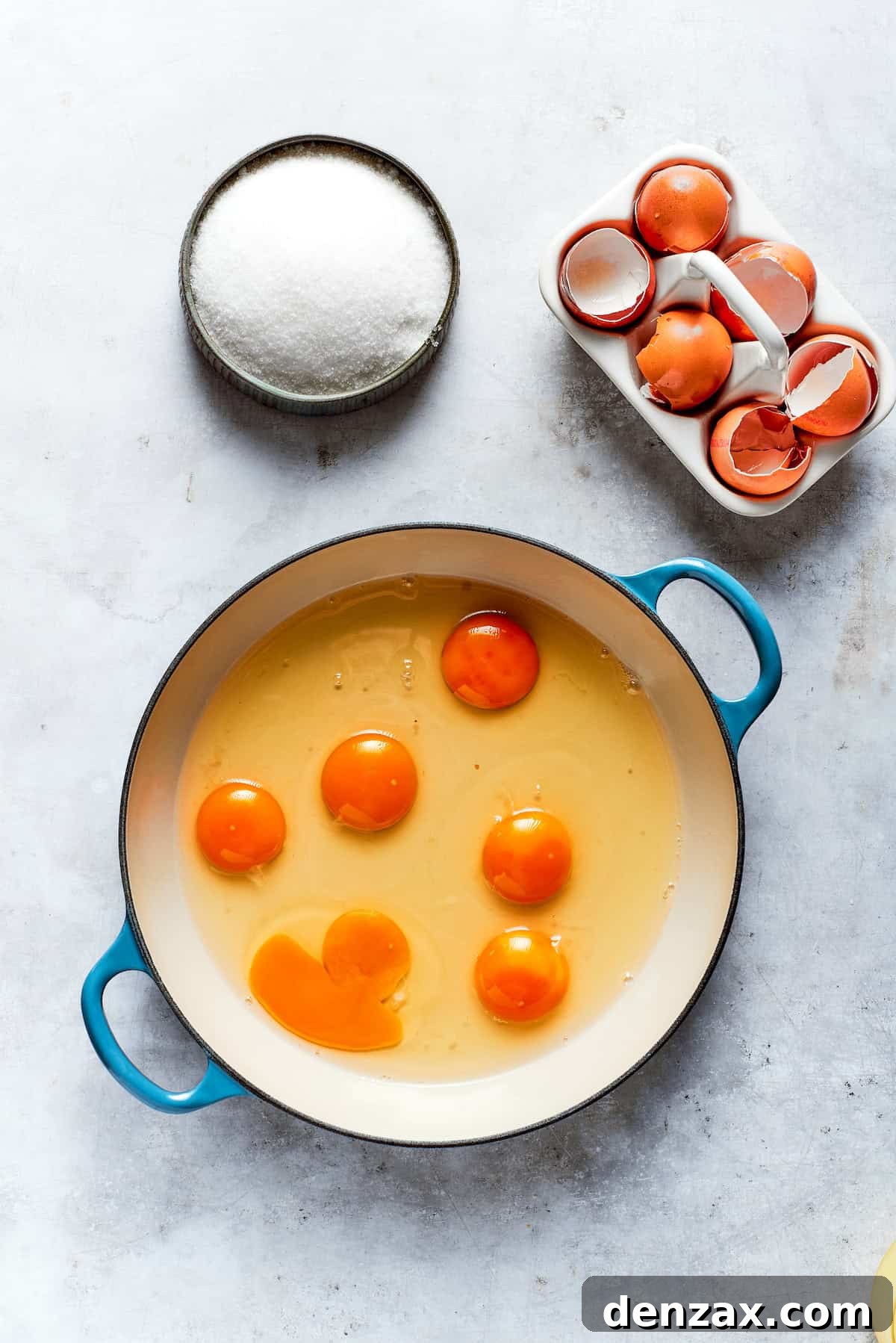 Eggs are carefully cracked into a heatproof bowl, ready to be mixed for the lemon curd.