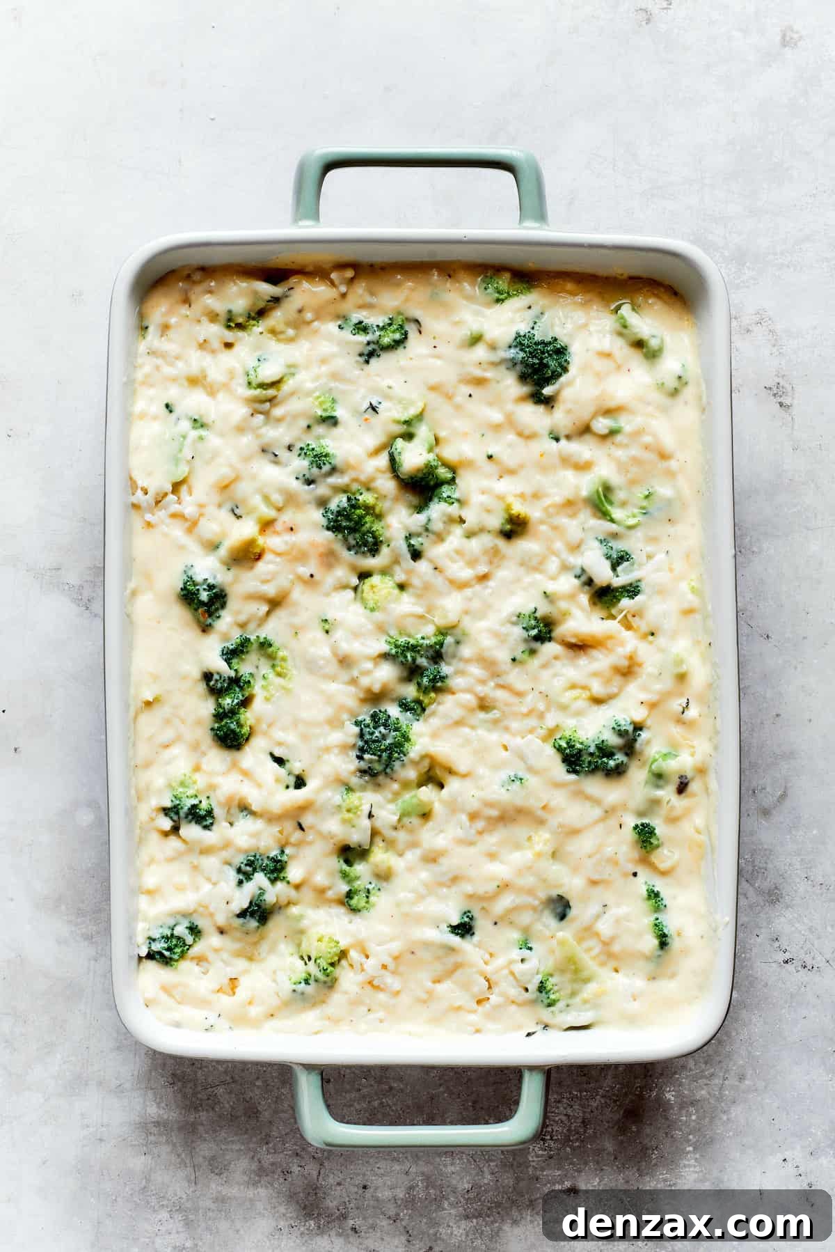 Broccoli and rice are mixed into cheese sauce in a pan for broccoli & rice casserole.