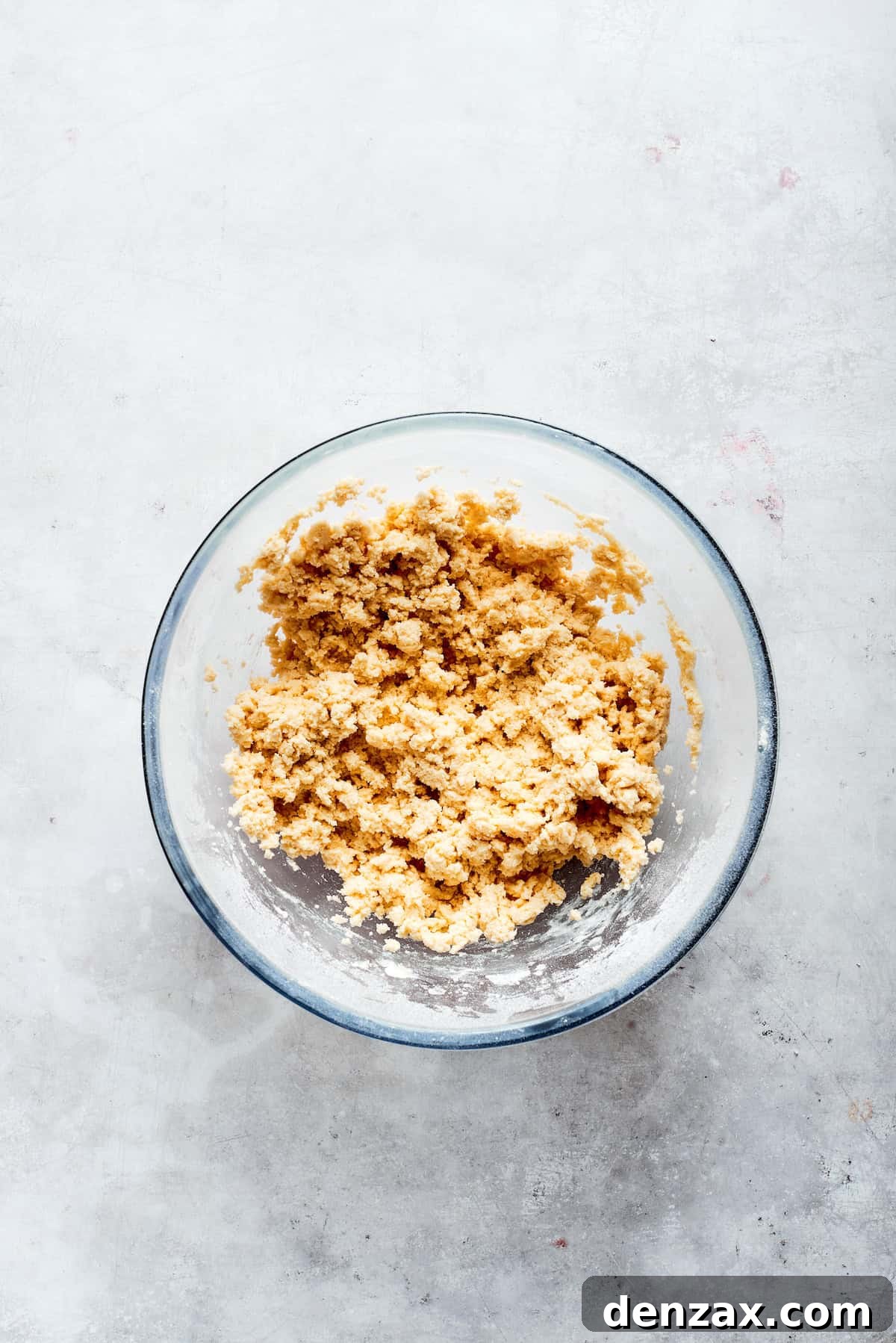 Shortbread dough in a bowl, showing its crumbly yet cohesive texture.