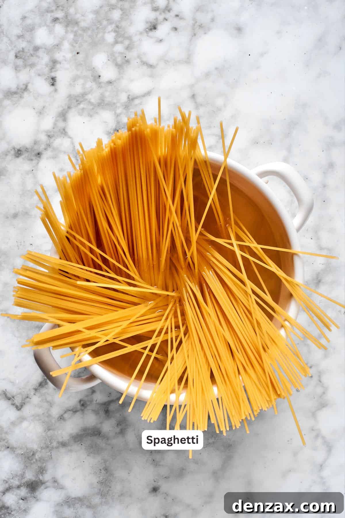 Spaghetti in a pot, being cooked to al dente perfection.
