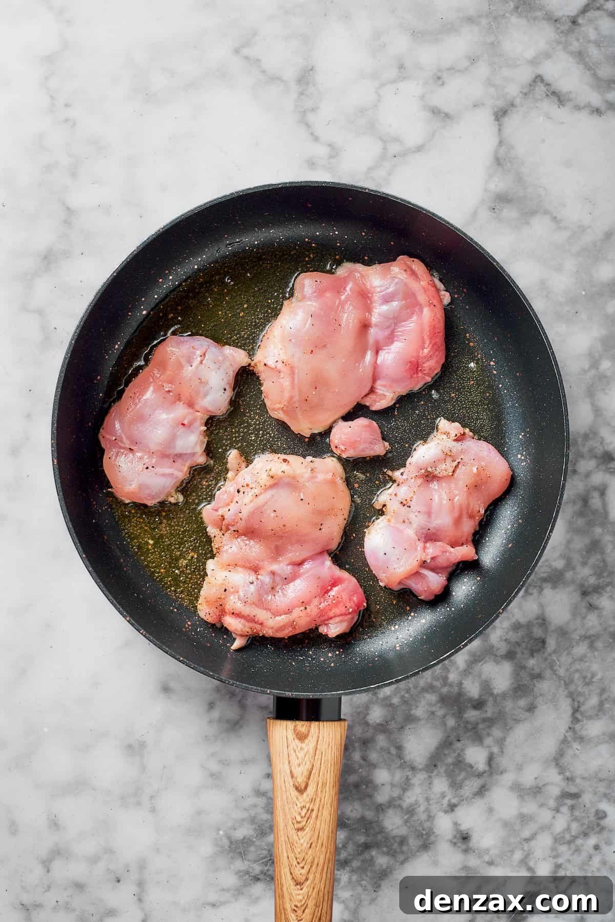 Cooking chicken in a skillet.