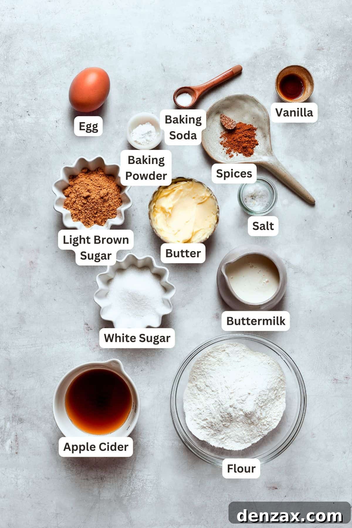 A flat lay photograph showcasing all the fresh ingredients for baking apple cider donuts, neatly arranged and ready for use.
