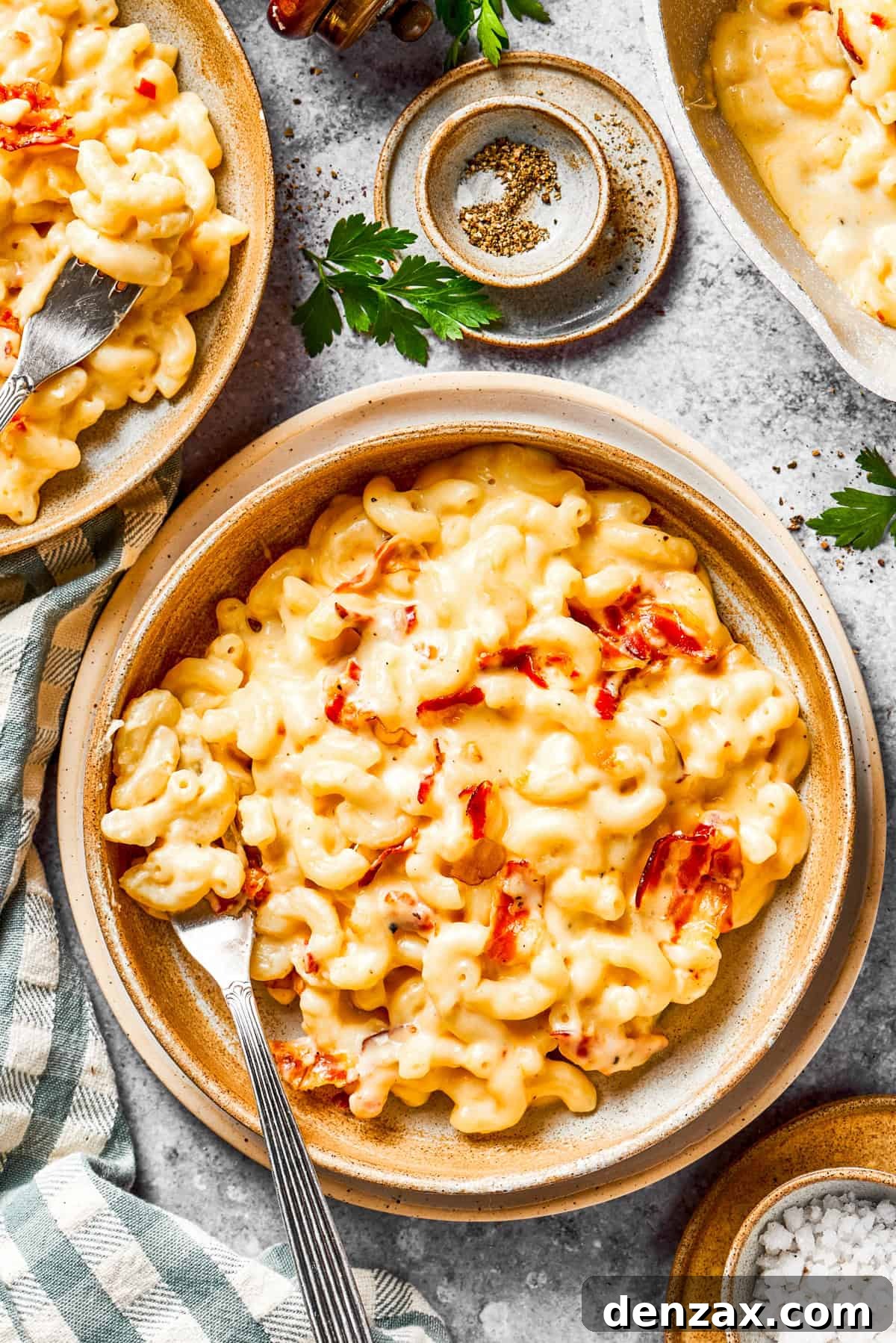 Several individual bowls of perfectly portioned bacon macaroni and cheese, ready to be enjoyed by family or guests.