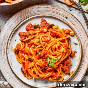 A plate of Mexican spaghetti garnished with cilantro and crema.
