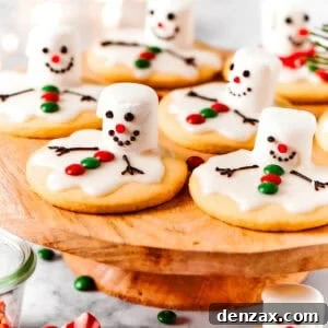 Oops My Snowman Melted Cookies 2 Melting snowman cookies are arranged on a cake plate.
