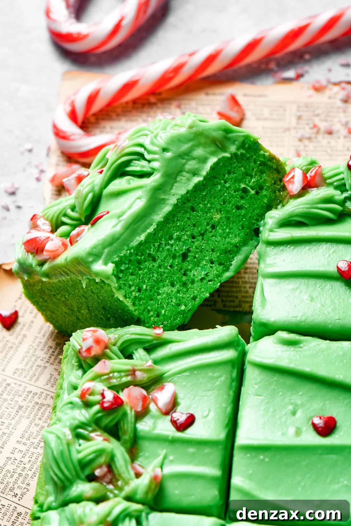 Moist and Tender Green Grinch Cake Slice A perfectly baked slice of green Grinch cake turned on its side, revealing its moist texture.