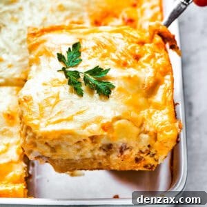 Scooping out a slice of casserole from the baking dish.