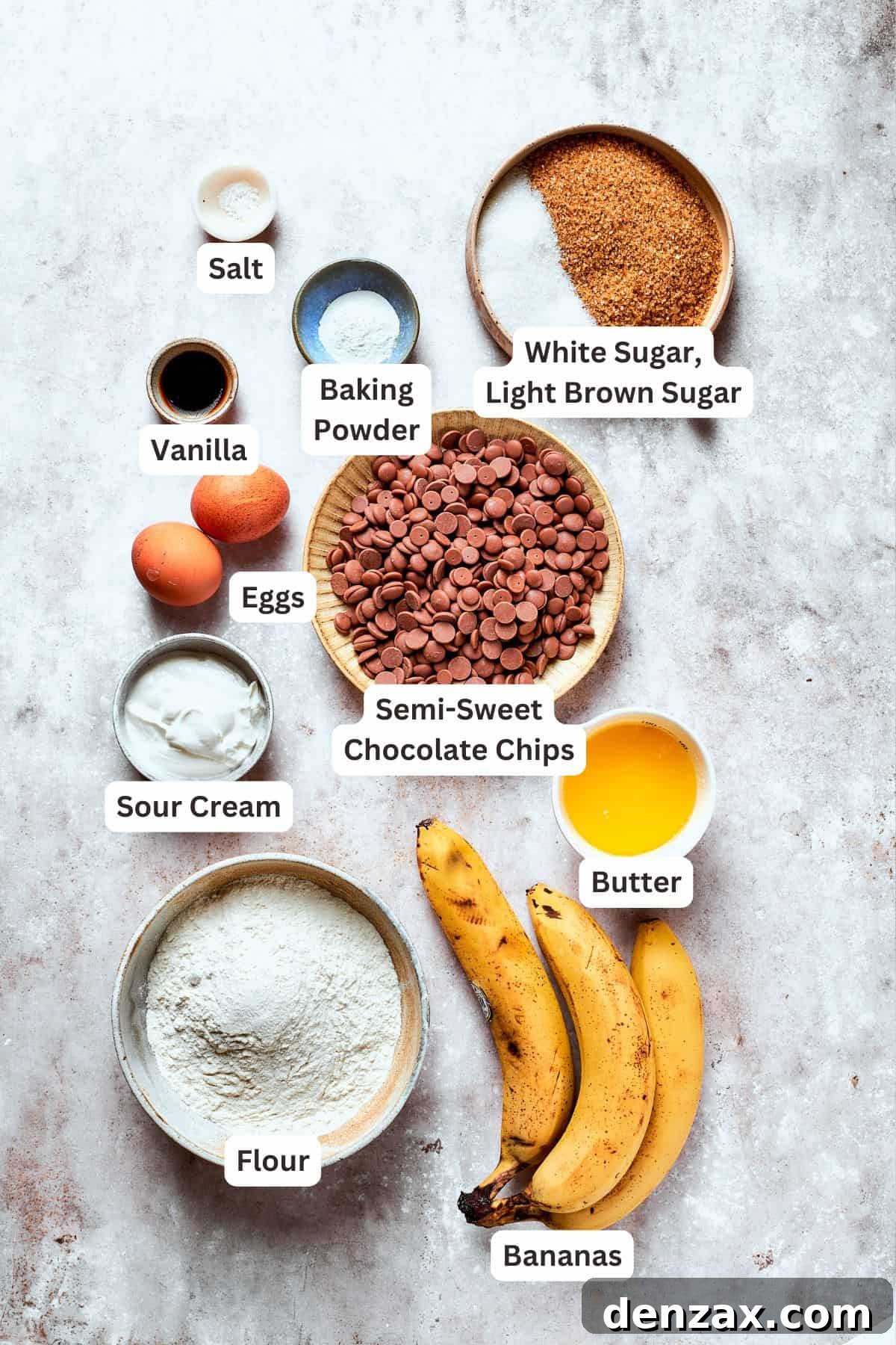 Ingredients for moist banana chocolate chip bread are clearly labeled on a countertop.