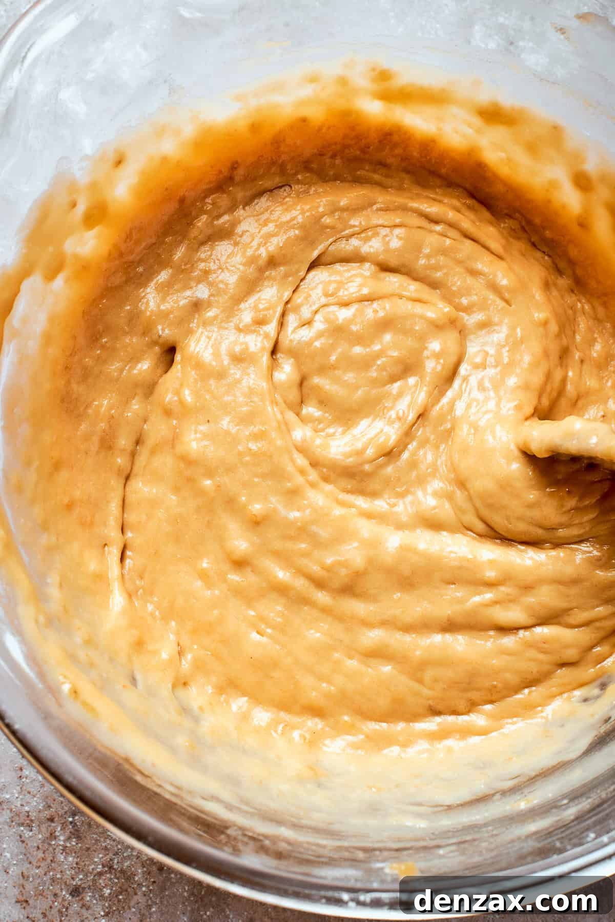A thick, smooth batter for banana bread in a mixing bowl, ready for chocolate chips.