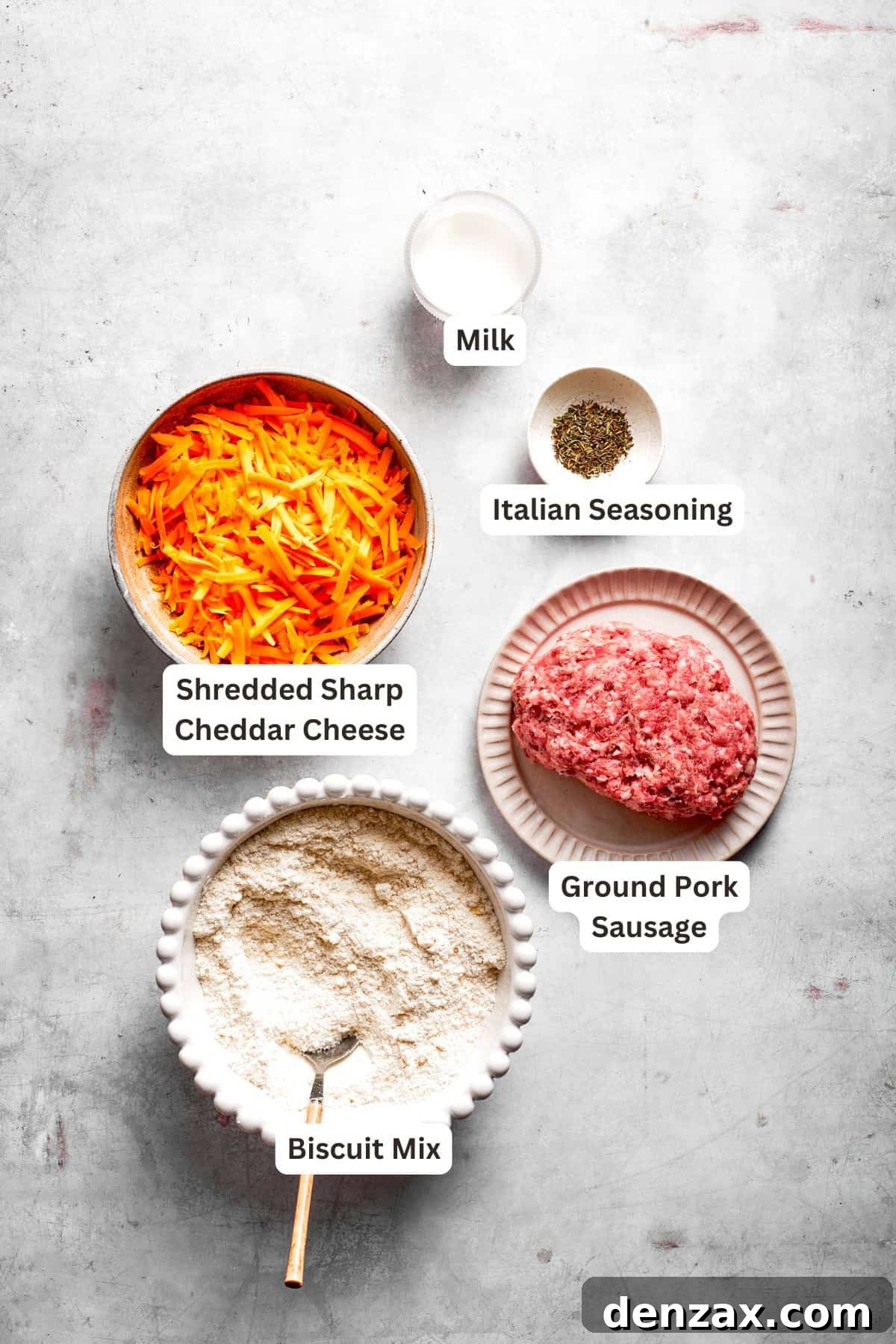 All the essential ingredients for making sausage balls are neatly arranged and clearly labeled for easy identification.