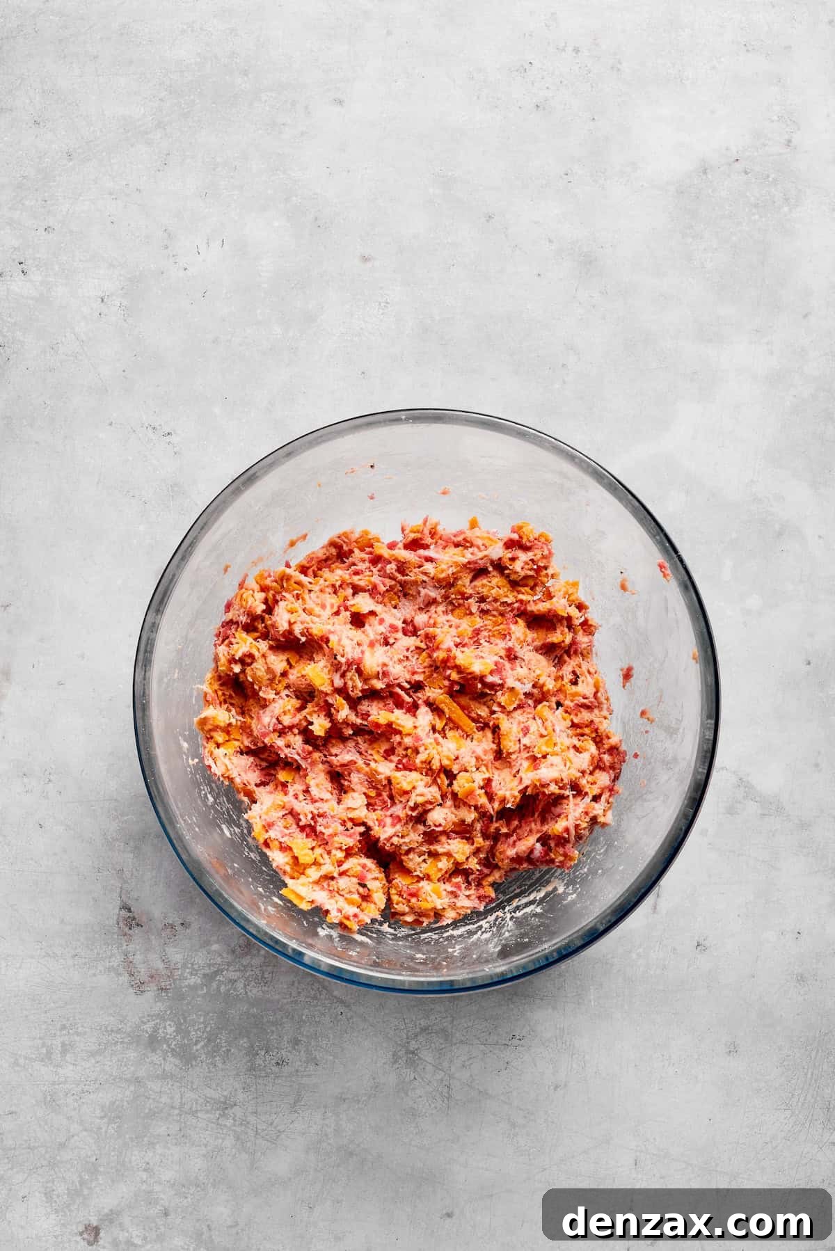 The sausage ball mixture is thoroughly combined in a bowl, showing its uniform texture, ready for shaping.