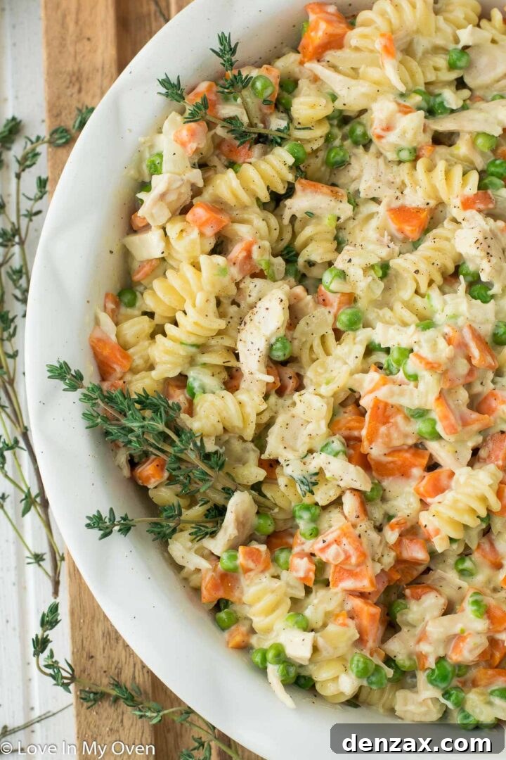 A large serving of Chicken Pot Pie Pasta in a rustic bowl