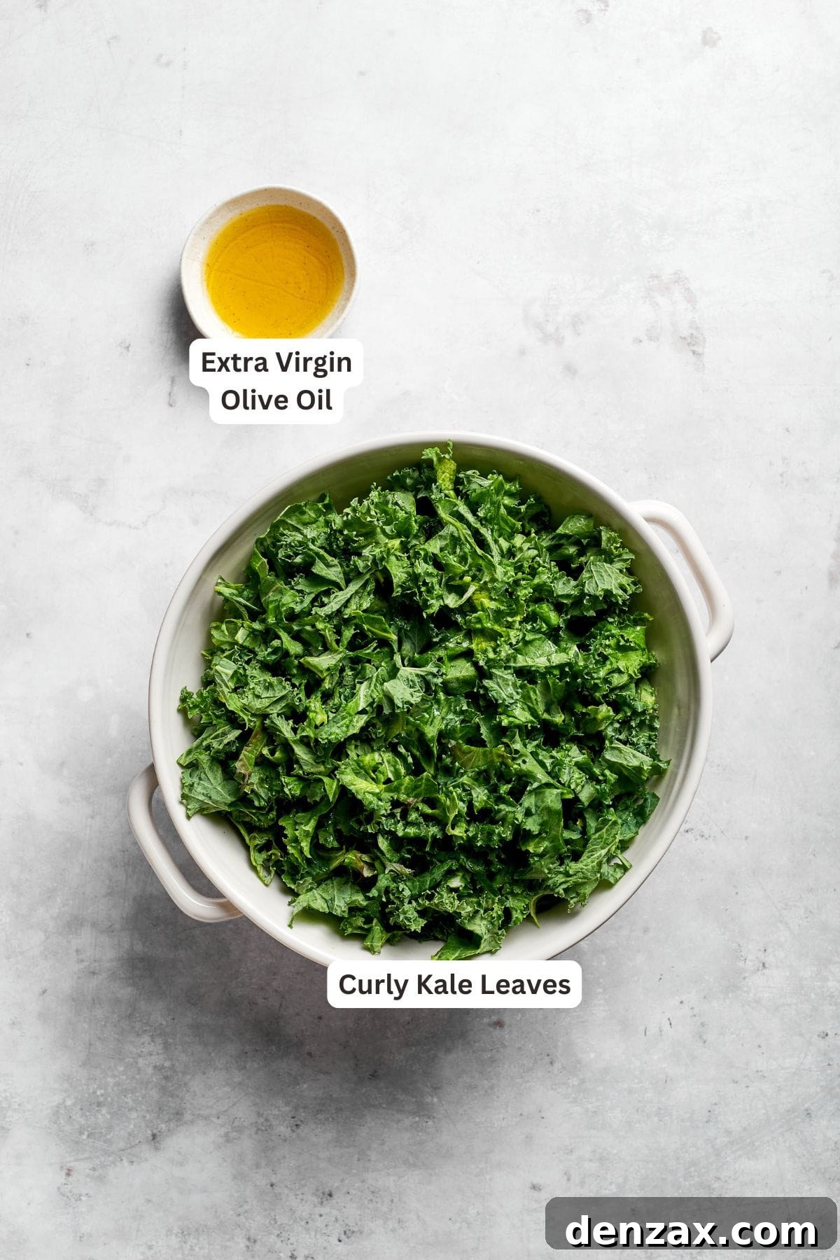 Fresh kale leaves and a bottle of olive oil, portioned for the salad, are clearly labeled.