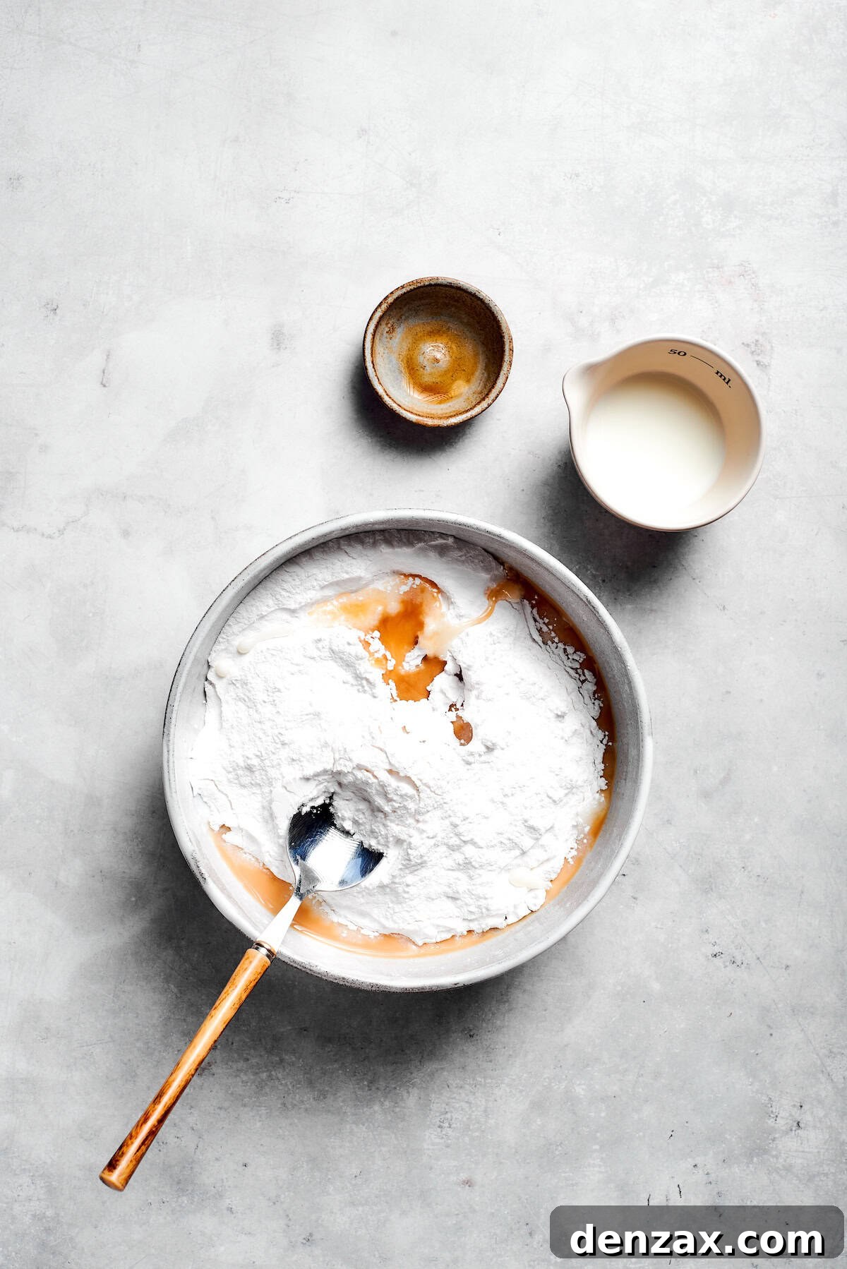 Icing is mixed in a bowl.