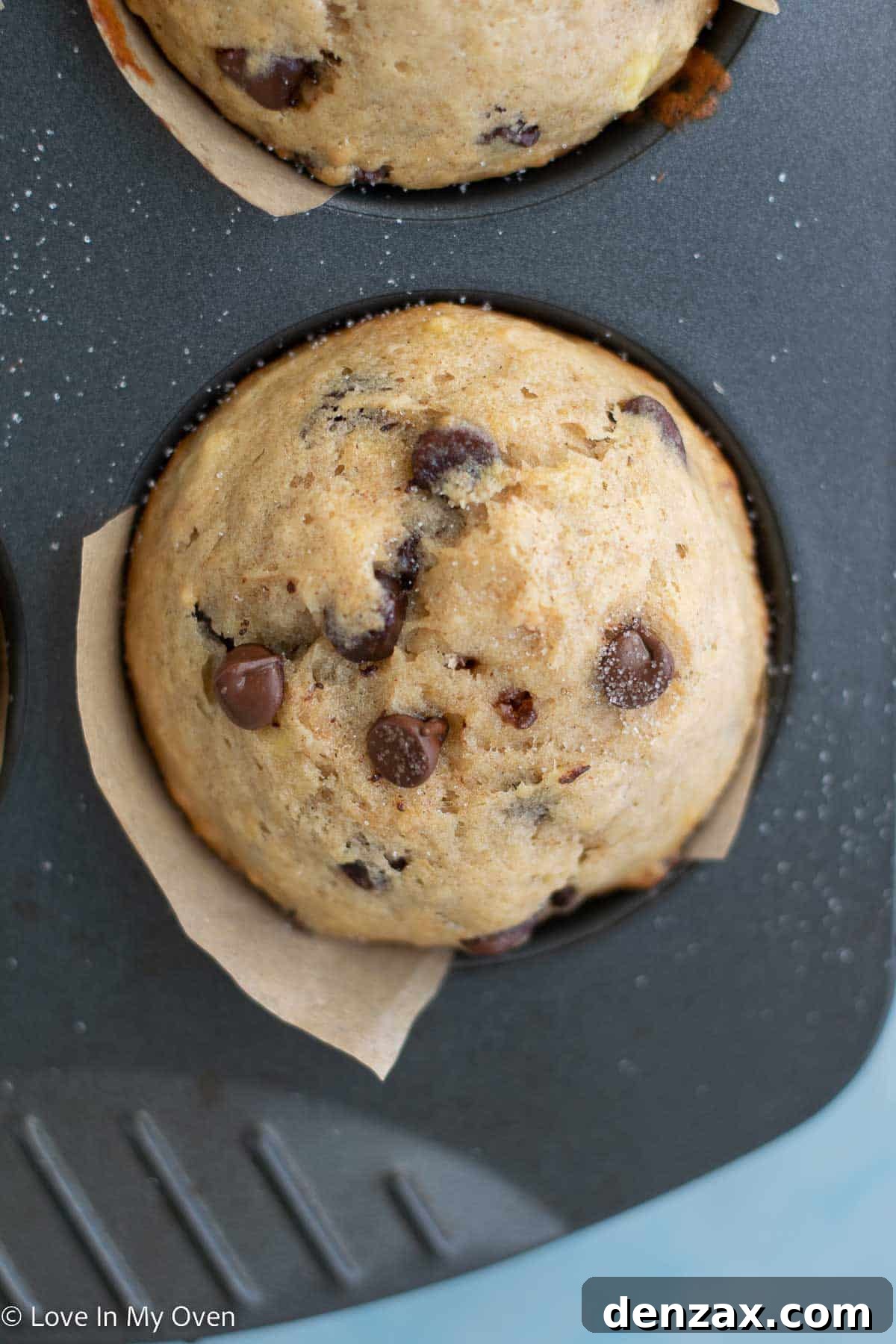 A basket full of homemade bakery style banana chocolate chip muffins, ready to be enjoyed.