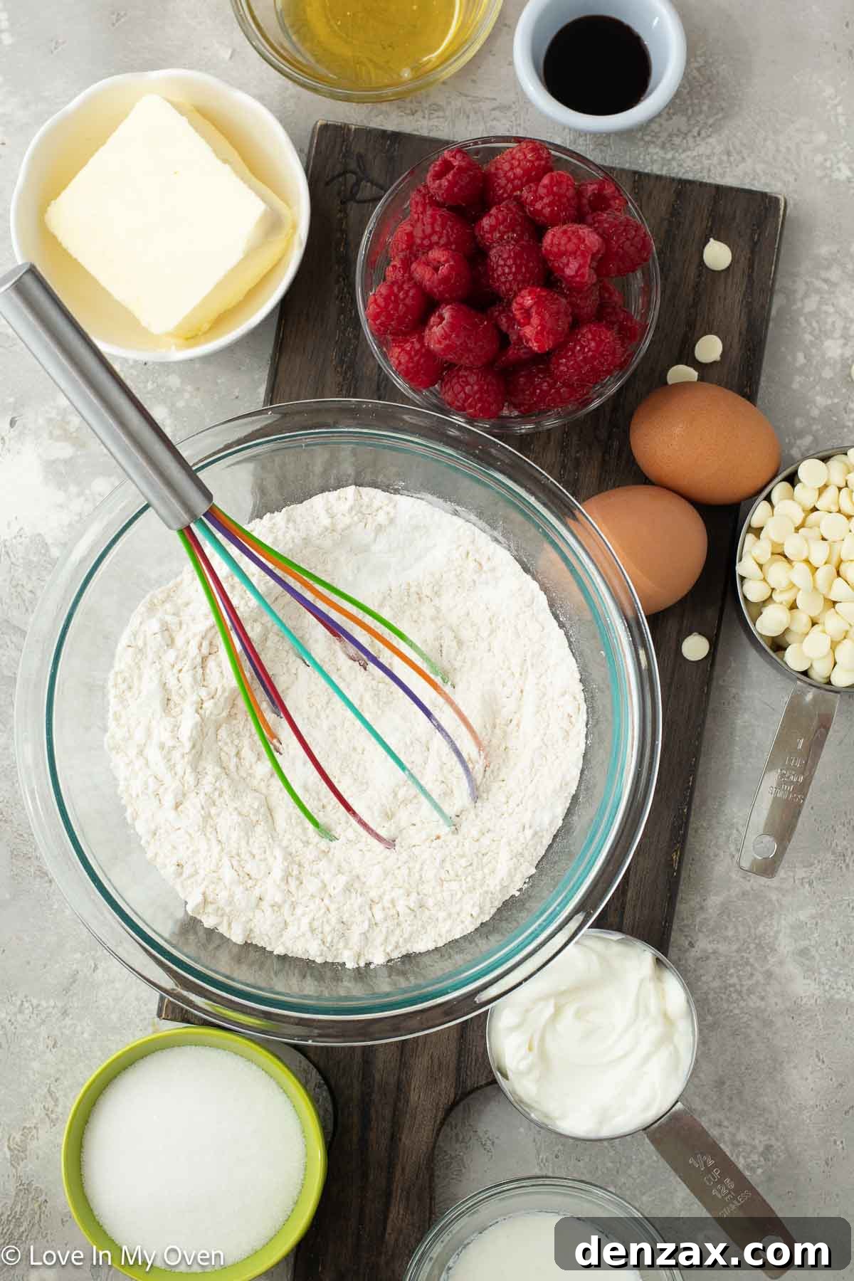 Sweet Raspberry White Chocolate Delights 3 Ingredients for raspberry white chocolate muffins laid out on a counter.