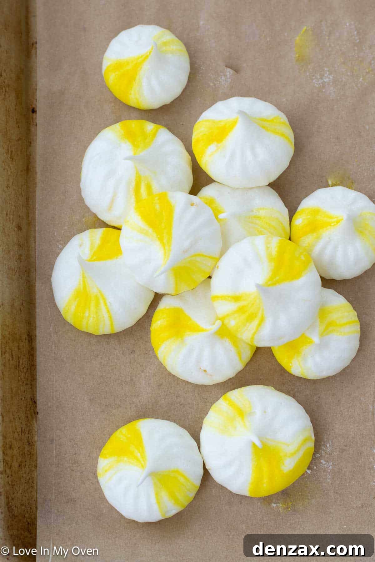 Baked lemon meringue cookies displayed beautifully on a serving plate, highlighting their delicate form and light color.