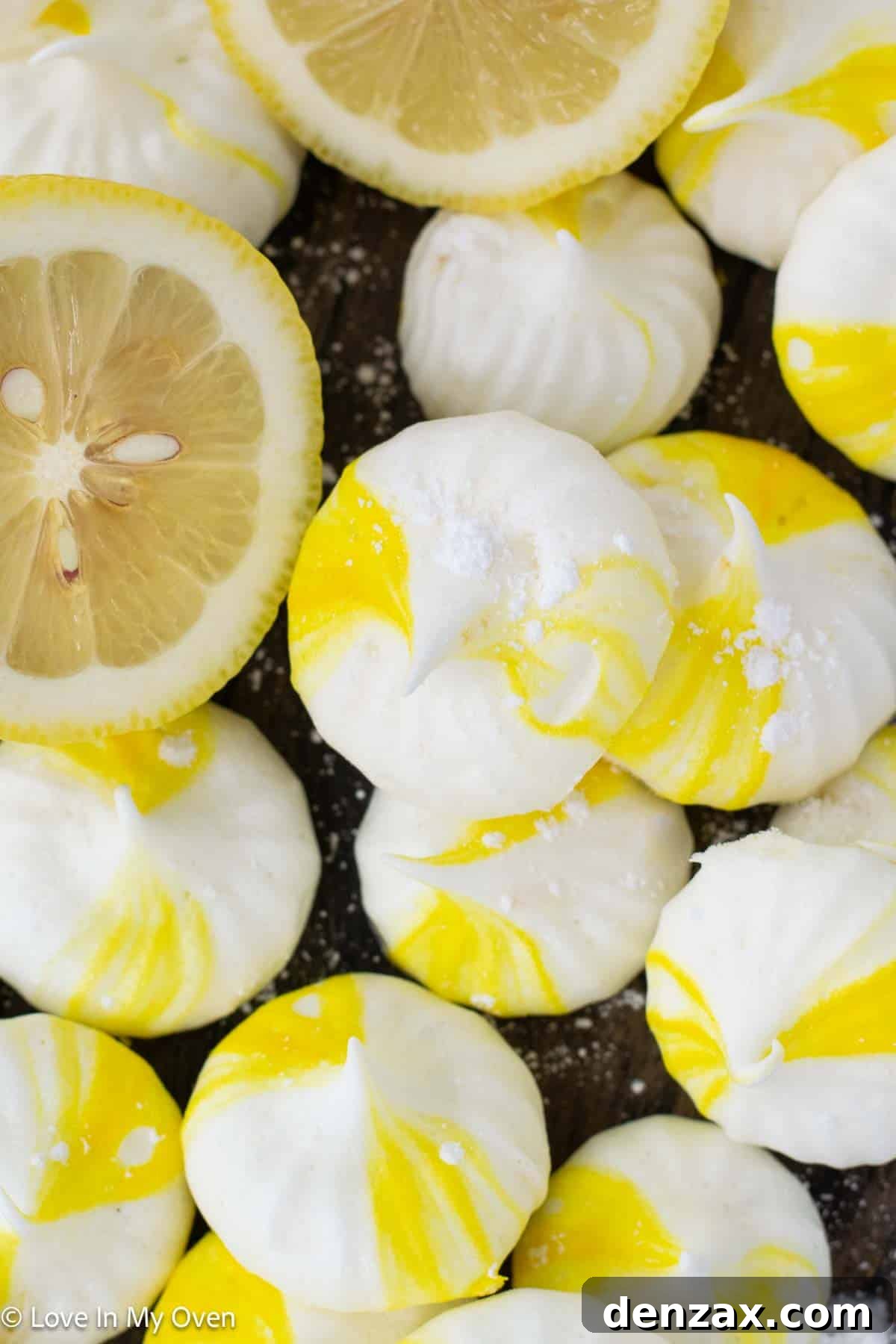 A close-up of a single lemon meringue cookie, showing its intricate swirl and crisp, airy texture.