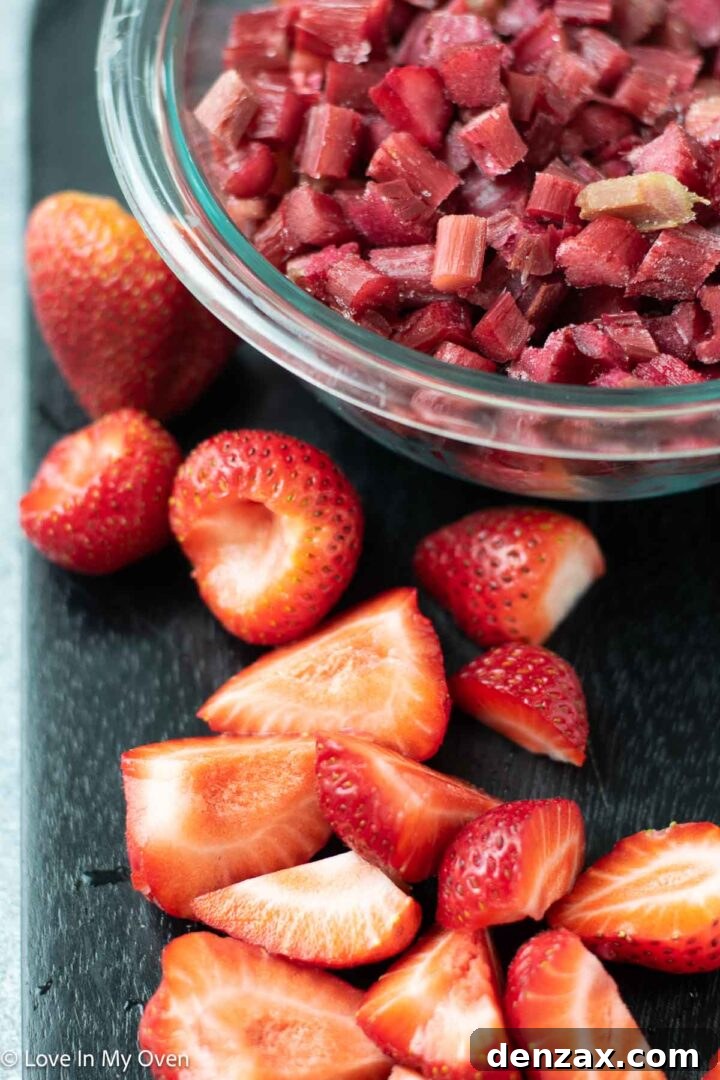 Fresh rhubarb and strawberries being chopped for compote