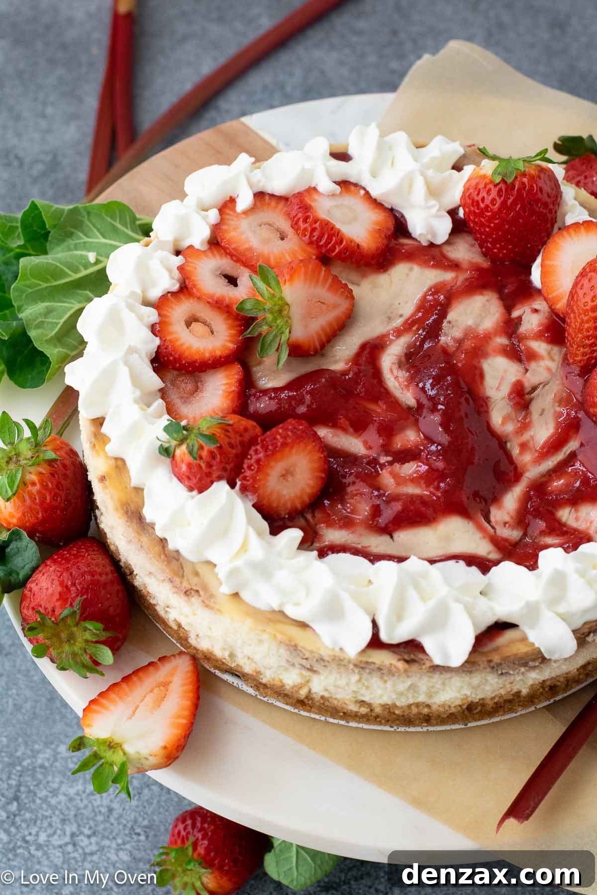 A beautifully decorated slice of strawberry rhubarb cheesecake on a plate