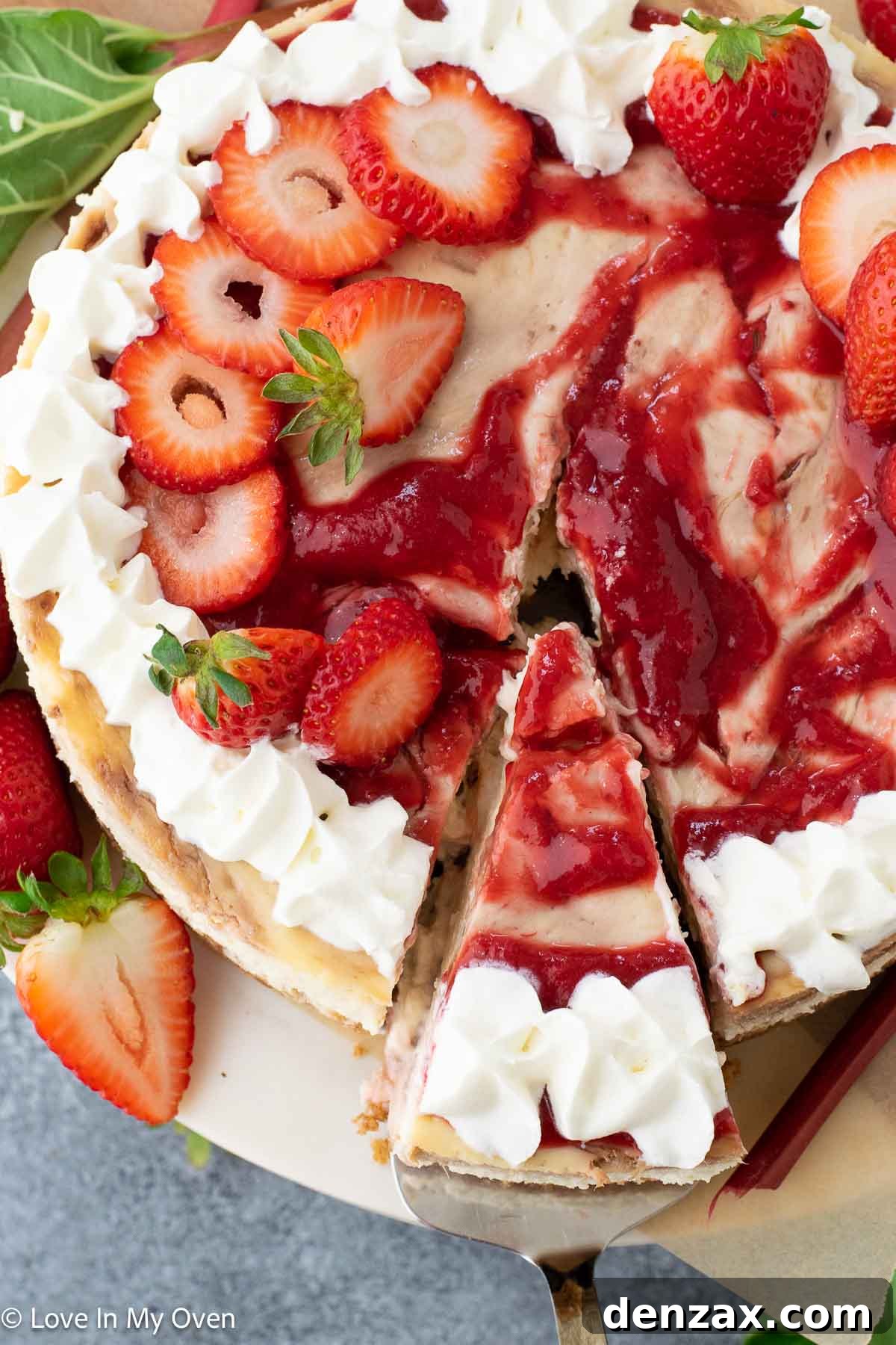Whole strawberry rhubarb cheesecake with fresh fruit toppings