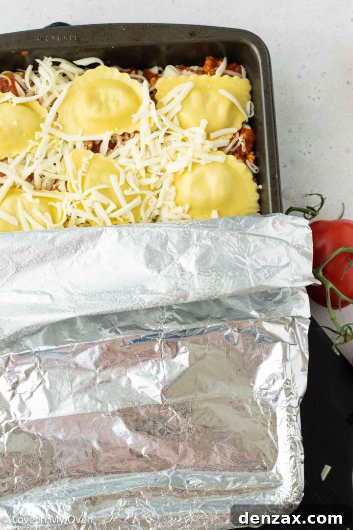 Assembling the final layers of Sausage Ravioli Bake